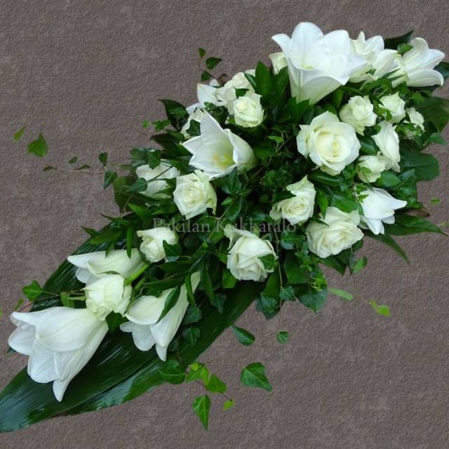 Valkoisista kukista sidottu hautajaiskimppu